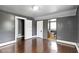 Bedroom with gray walls, wood floors, two doors, and an en-suite bathroom at 1021 W 37Th St, Indianapolis, IN 46208