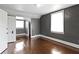 Bedroom featuring gray walls, wood floors, closet, and two windows at 1021 W 37Th St, Indianapolis, IN 46208