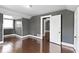 Bedroom featuring gray walls, wood floors, closet, and a window at 1021 W 37Th St, Indianapolis, IN 46208
