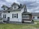 Side view of a two-story home with white siding, black shutters, and a well-maintained lawn at 1021 W 37Th St, Indianapolis, IN 46208
