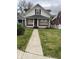 Charming two-story home with a brick foundation, front yard, and sidewalk leading to the front door at 1021 W 37Th St, Indianapolis, IN 46208