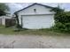 Garage with a large white door surrounded by greenery at 1021 W 37Th St, Indianapolis, IN 46208