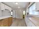 View of kitchen showcasing white cabinets, laminate flooring, and a bright yellow door in the background at 1021 W 37Th St, Indianapolis, IN 46208