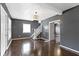 Spacious living room with hardwood floors, staircase, and views into an adjacent room at 1021 W 37Th St, Indianapolis, IN 46208