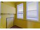 Room with yellow walls and trim and two windows with blinds at 1021 W 37Th St, Indianapolis, IN 46208