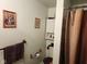 Cozy bathroom featuring a decorative shower curtain, white storage cabinet, and a towel rack for convenience at 10307 Orchard Park S Dr, Carmel, IN 46280