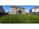 Large, well-maintained backyard featuring a covered patio, lush green grass, and wood fence providing a private outdoor space at 1065 Park Ct, Avon, IN 46123