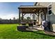 Inviting backyard patio with an open pergola, grill, and outdoor seating, overlooking the lawn at 1065 Park Ct, Avon, IN 46123