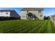 Spacious backyard showcasing lush green lawn, wood fence, and covered patio, perfect for outdoor enjoyment and entertaining at 1065 Park Ct, Avon, IN 46123