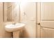 Bright bathroom features a pedestal sink with silver fixtures, a mirror, and fresh white walls at 1065 Park Ct, Avon, IN 46123