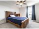 Bedroom featuring carpet, a ceiling fan, and window providing ample natural light with a wooden frame bed and matching furniture at 1065 Park Ct, Avon, IN 46123