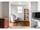 A bonus room featuring wood floors, a ceiling fan, and large window for natural light as well as bonus cabinet shelving at 1065 Park Ct, Avon, IN 46123