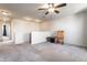 Upstairs bonus room with neutral walls and carpeting, a ceiling fan and a wooden rocking chair and table in a cozy space at 1065 Park Ct, Avon, IN 46123