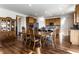Dining area adjacent to the kitchen, featuring hardwood floors, wooden dining set, and ample space for Gathering gatherings at 1065 Park Ct, Avon, IN 46123