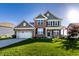 Charming two-story brick home with a well-manicured lawn and attached two-car garage, perfect for Gathering living at 1065 Park Ct, Avon, IN 46123
