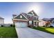 Attractive two-story home featuring a brick facade, a two-car garage, and a spacious driveway, with an inviting appeal at 1065 Park Ct, Avon, IN 46123