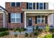 Welcoming covered front porch with brick accents, black shutters, and manicured landscaping leading to the front door at 1065 Park Ct, Avon, IN 46123