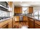 Well-equipped kitchen boasting granite countertops, wood cabinets, and stainless steel appliances at 1065 Park Ct, Avon, IN 46123