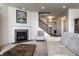 Cozy living room with a fireplace, staircase, and neutral decor creating a warm and inviting space for relaxation and gatherings at 1065 Park Ct, Avon, IN 46123