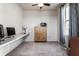 A home office with carpet, a ceiling fan, a large window providing lots of natural light, and built-in shelving at 1065 Park Ct, Avon, IN 46123