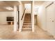 Carpeted staircase with wooden handrail leads to the basement, with neutral walls and trim at 1065 Park Ct, Avon, IN 46123