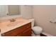 Powder room with wooden vanity and a sink with a simple mirror and towel rack at 10722 Mistflower Way, Indianapolis, IN 46235