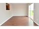 Dining area with hardwood floors, neutral paint, and sliding glass door to the backyard at 10722 Mistflower Way, Indianapolis, IN 46235