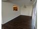 Dining room featuring hardwood floors, stylish lighting, and a view to the kitchen at 10722 Mistflower Way, Indianapolis, IN 46235