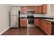 Well-equipped kitchen featuring stainless steel appliances and dark countertops at 10722 Mistflower Way, Indianapolis, IN 46235