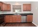 Kitchen boasts stainless steel dishwasher, ample cabinet space, and sleek black countertops at 10722 Mistflower Way, Indianapolis, IN 46235