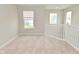 Hall landing with carpet and wooden banister and views from multiple windows at 10722 Mistflower Way, Indianapolis, IN 46235