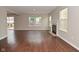 Bright living room featuring hardwood floors, a fireplace, and large windows at 10722 Mistflower Way, Indianapolis, IN 46235