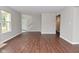 Spacious living area with hardwood floors, bright light, and staircase to the upper floor at 10722 Mistflower Way, Indianapolis, IN 46235