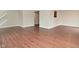 Open living space with hardwood floors, a staircase, and a view to the kitchen at 10722 Mistflower Way, Indianapolis, IN 46235