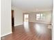 Open-concept living room featuring hardwood floors and a sliding glass door to the patio at 10722 Mistflower Way, Indianapolis, IN 46235