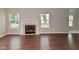 Living room featuring hardwood floors, a fireplace, and lots of natural light at 10722 Mistflower Way, Indianapolis, IN 46235