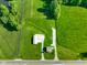 Birds eye view shows home, outbuilding and expansive green lot on a sunny day at 10758 W State Road 142, Quincy, IN 47456