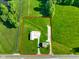 Aerial view showing the house, outbuilding, and expansive green lot outlined in red at 10758 W State Road 142, Quincy, IN 47456