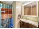 Bathroom featuring a vanity with a mirror, shower, and colorful curtain at 10758 W State Road 142, Quincy, IN 47456