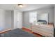 Bright bedroom with hardwood floors, a comfortable bed, and natural light from the window at 10758 W State Road 142, Quincy, IN 47456