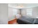 Cozy bedroom featuring hardwood floors, a comfortable bed, and natural light from the windows at 10758 W State Road 142, Quincy, IN 47456