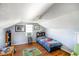 Cozy bedroom featuring sloped ceilings and hardwood floors at 10758 W State Road 142, Quincy, IN 47456