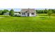 Charming one-story house featuring a well-maintained lawn, an exterior propane tank, and supplemental storage structures at 10758 W State Road 142, Quincy, IN 47456