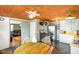 Functional kitchen featuring a rustic wood ceiling, modern stainless steel appliances, and an adjacent dining area at 10758 W State Road 142, Quincy, IN 47456