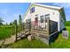 Exterior shot of house with a charming front porch and green lawn under a blue sky at 10758 W State Road 142, Quincy, IN 47456
