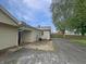 A view of the backyard and exterior of the home with driveway, siding, and a fenced in yard at 108 N A St, Elwood, IN 46036