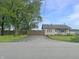 View of the front yard with a driveway leading to a single story home at 108 N A St, Elwood, IN 46036