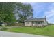 Charming single story home featuring a lush lawn and matching shutters at 108 N A St, Elwood, IN 46036