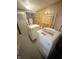 Functional laundry room with modern washer and dryer, plus water heater and gray flooring at 108 N A St, Elwood, IN 46036