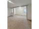 An open concept living room with fresh paint and neutral carpeting at 108 N A St, Elwood, IN 46036